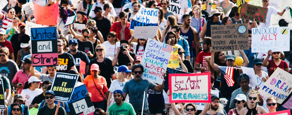 A photo from a protest support DACA. Posters have messages like "United and Strong," "Stay Strong Dreamers. You Are Loved And Wanted," and "Los Angeles Stands With Dreamers."