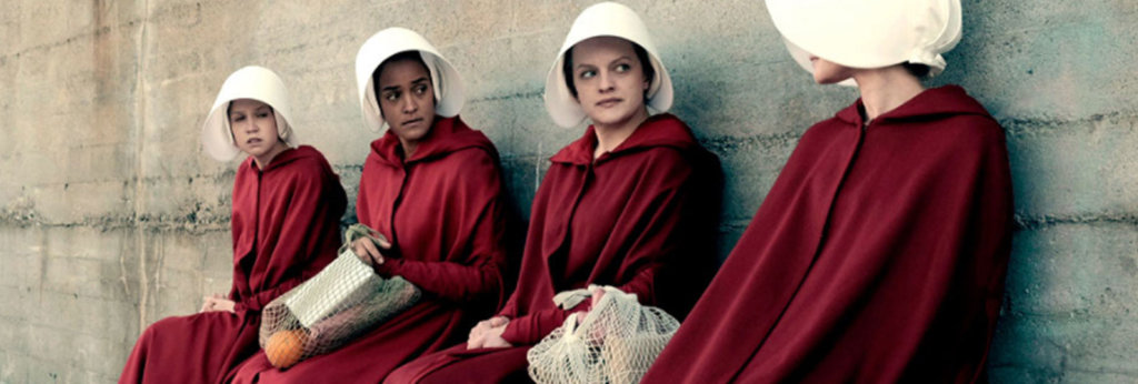 A still from the show, "The Handmaid's Tail." Women are wearing red robes and white bonnets.