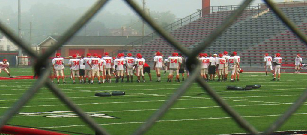 A photo of football players on a football field.