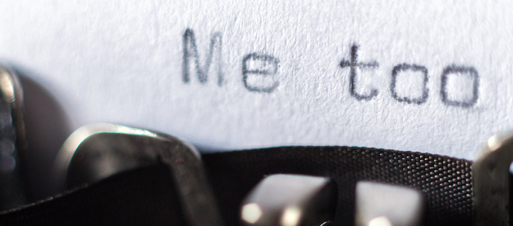 The text "Me Too" coming out of a typewriter