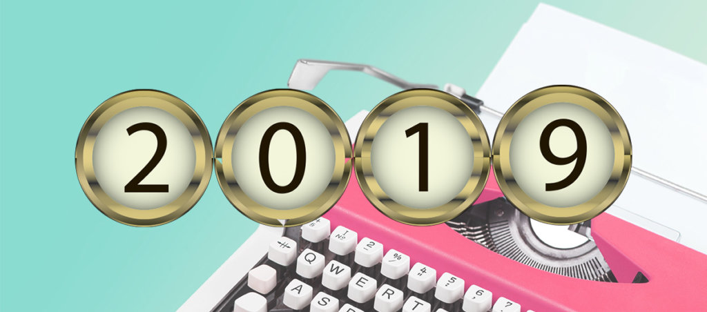 A collage of a pink typewriter in the background and buttons that say "2019" in the front.