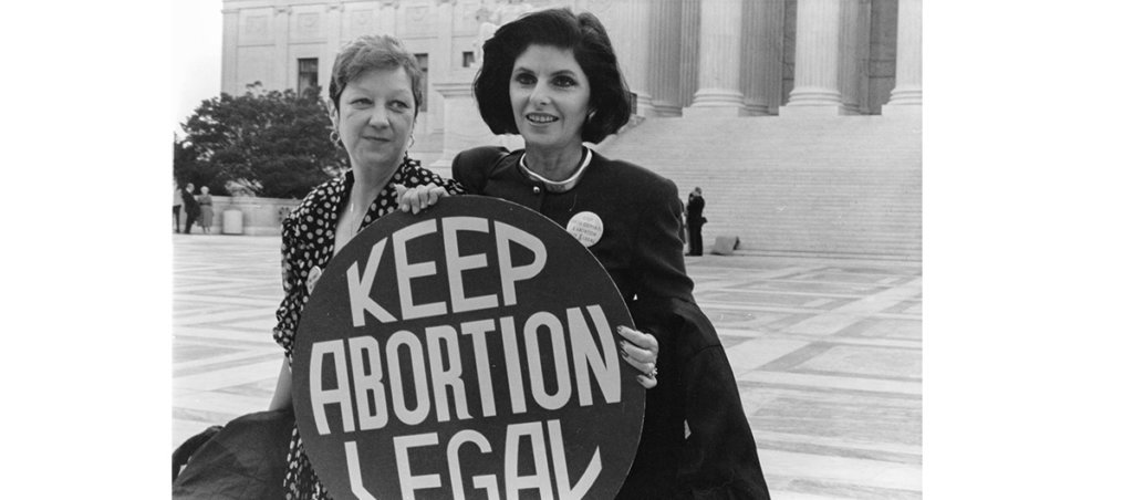 A black and white photo of two women holding a sign that says, "Keep Abortion Legal."