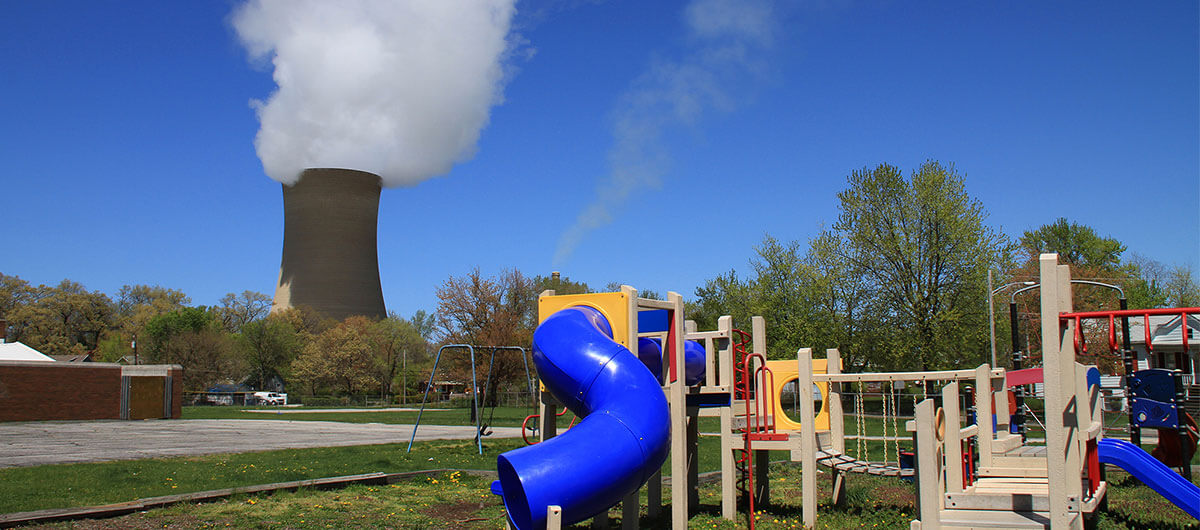 Children's playground in front of a power plant.