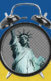 The Statue of Liberty in a clock that's ringing, and in the background are blue and yellow stripes